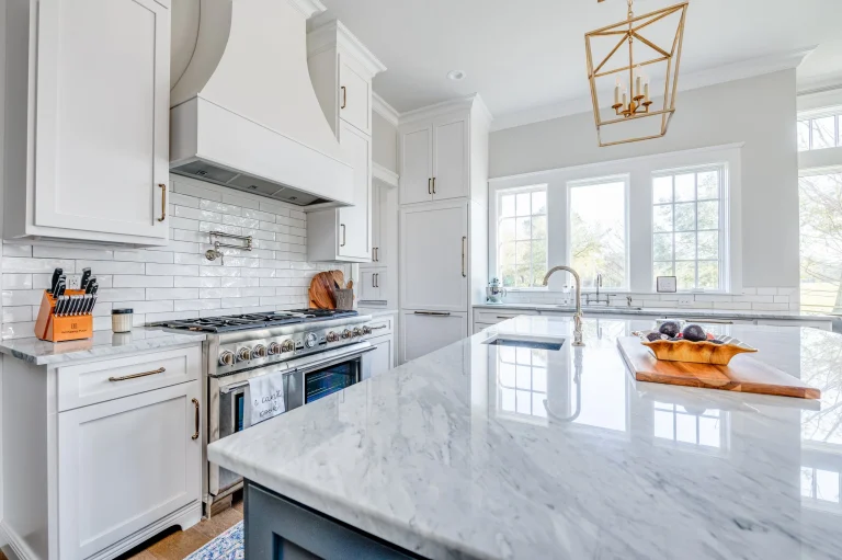 Home 10 A Kitchen With White Cabinets And Marble Counter Tops