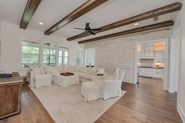 Home 17 A Large White Living Room With A White Couch And A White Ceiling Fan