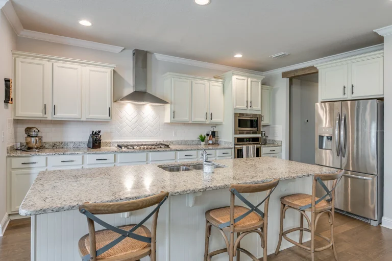 Home 7 A Kitchen With A Marble Countertop And Chairs